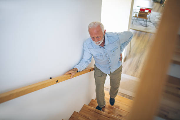 istock Senior man climbing on stairs with pain in his back 2180927983