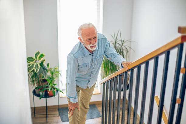 istock Senior man climbing on stairs with pain on knee 2180928108