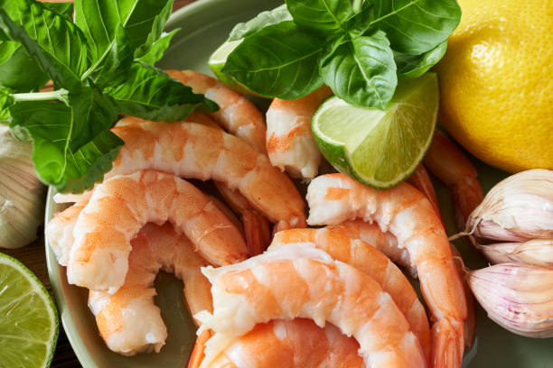 istock Shrimps and ingredients for cooking on wooden table, closeup 2180929599