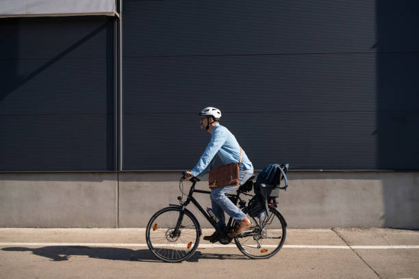 istock Mid-adult Caucasian man commuting to the work with an bicycle 2180931731