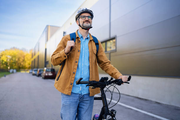 istock Mid-adult Caucasian man pushing the bicycle, while commuting to the work 2180931760