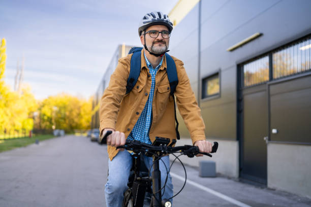 istock Modern mid-adult Caucasian man commuting to the work with an bicycle 2180931838