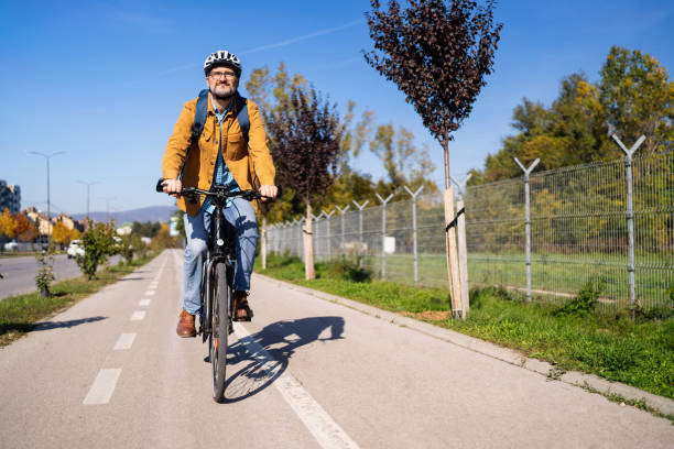 istock Mid-adult Caucasian man commuting to the work with an bicycle 2180931890