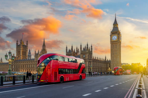 istock Double-decker buses on Westminster bridge and Big Ben tower at sunset, London, UK 2180932054