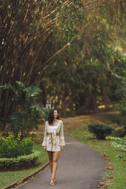 istock Woman Strolling Along Scenic Path In Royal Botanic Gardens, Peradeniya 2180936346