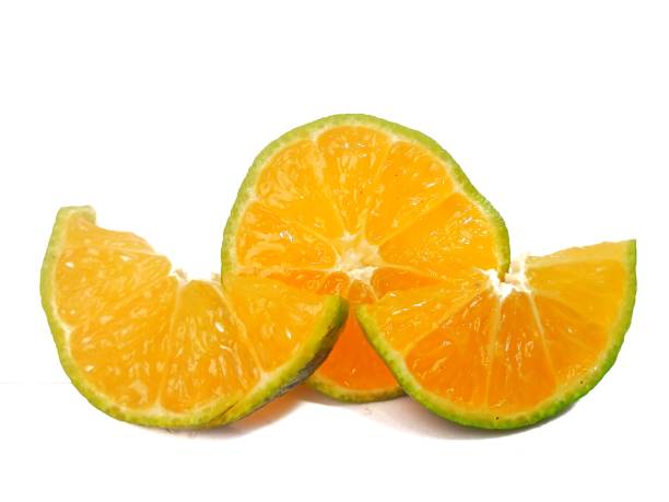 istock half lemon and slice isolated on white background. orange peel is green. 2180937493