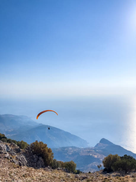 istock Paraglider Soaring Above Scenic Coastal Landscape at Sunset 2180942055