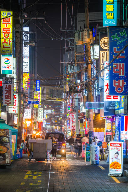 Seoul neon night bright lights busy downtown streets cityscape Korea People walking through the neon lit night streets of Seoul, South Korea’s vibrant capital city. kangnamgu stock pictures, royalty-free photos & images