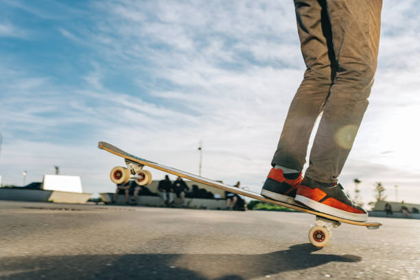istock Skateboarder balancing on one wheel at skatepark 2180943191