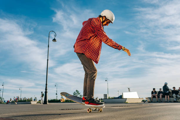 istock Young man maintaining balance riding longboard in skatepark 2180944017