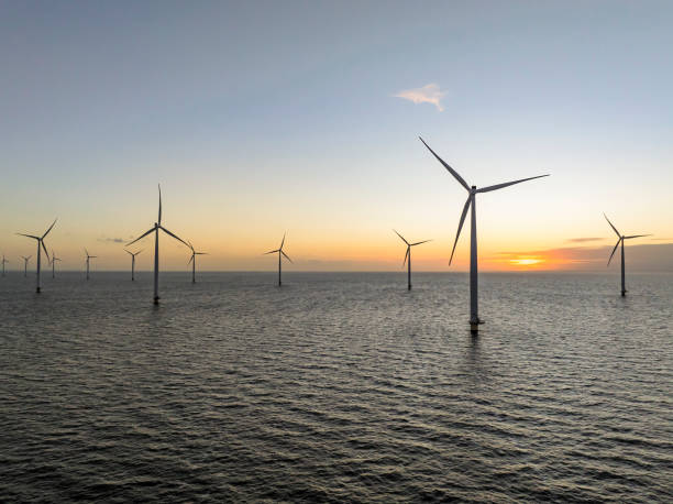 istock Wind turbines in an offshore wind park producing electricity 2180944353