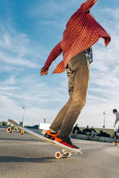 istock Skateboarder balancing on board in skatepark at sunset 2180944371