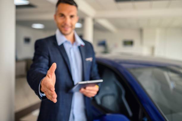 istock Businessman offering a handshake in the showroom 2180944579