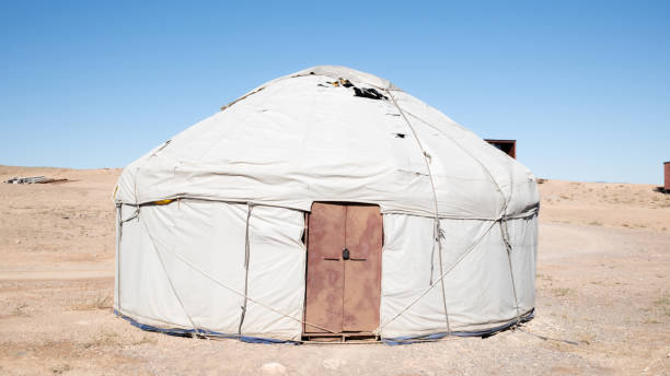 istock Traditional kazakh yurt camp. White circular tents in desert setting with clean blue sky 2180949371