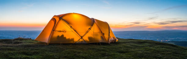 istock Hiking dome tent wild camping mountain ridge overlooking valley panorama 2180949885