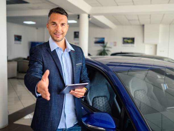 istock Businessman offering a handshake in the showroom 2180950181