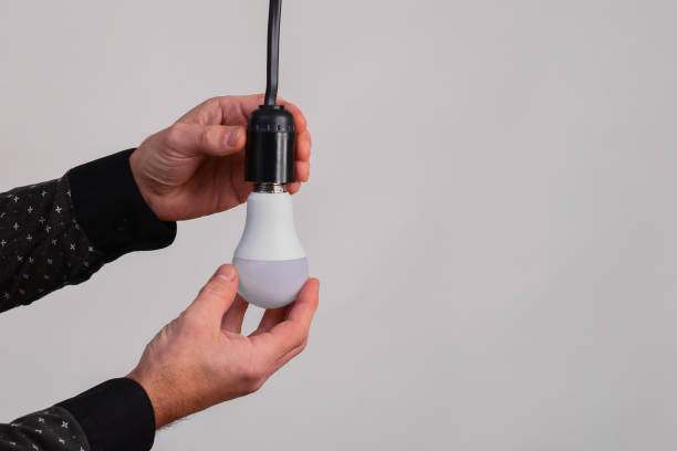 istock an LED lamp in the hands of a man. The concept 2180952049
