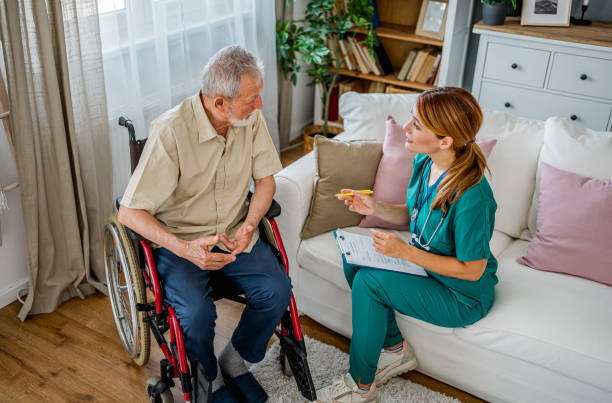 istock Home nurse visiting disabled senior male patient at home 2180952881