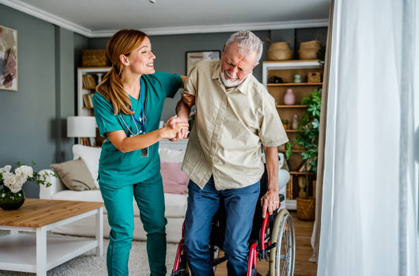istock Nurse helping a senior man get up from a wheelchair 2180953432