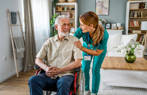 istock Senior man with home caregiver 2180953525