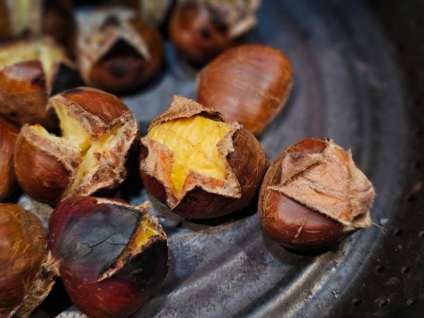 istock Close up of grilled chesnuts on pan. 2180953662