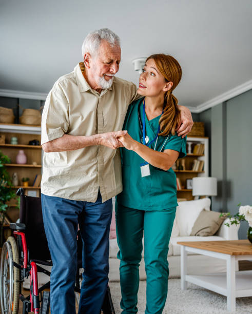 istock Female nurse supporting senior man to walk 2180953742