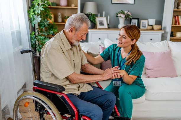 istock Home nurse caring for an elderly patient in a wheelchair 2180954164