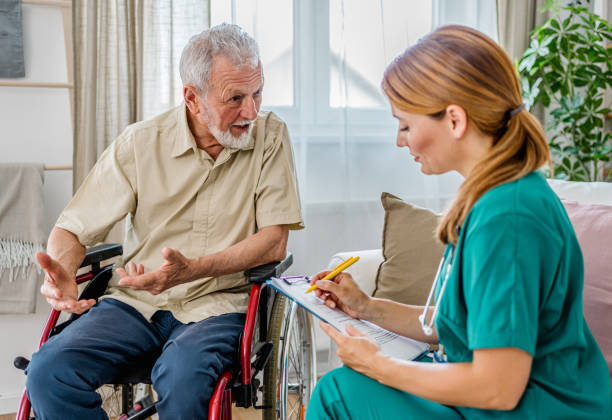 istock Home nurse visiting disabled senior male patient at home 2180954426