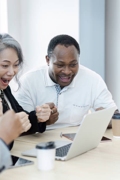 istock Diverse Business Team Celebrating Success Together in Modern Office Environment 2180954826