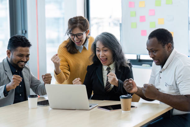 istock Diverse Group of Colleagues Celebrating Success in Modern Office Environment 2180954859