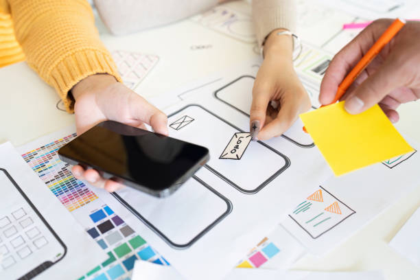 istock Designers Collaborating on UX UI Mobile App Wireframes and Prototypes with Color Swatches and Notes 2180954965