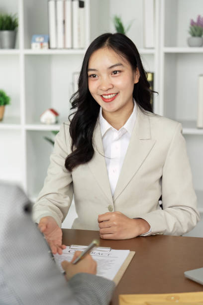 istock Professional Businesswoman in a Job Interview Setting, Smiling and Engaging with Interviewer in Modern Office 2180955351