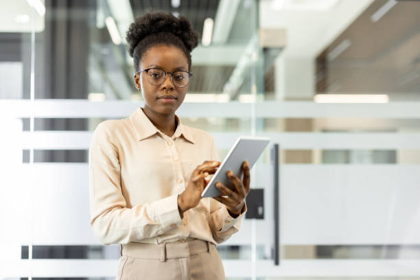 istock Confident businesswoman using tablet in modern office space for digital tasks and professional management 2180955780