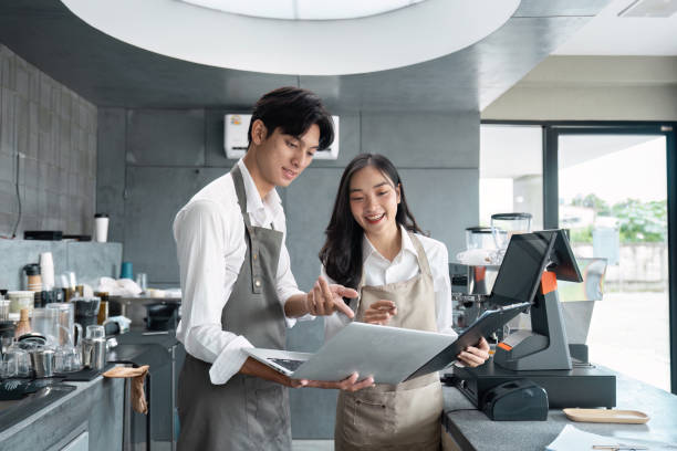istock Young Entrepreneurs Working Together in a Modern Cafe Startup Business Environment 2180957916