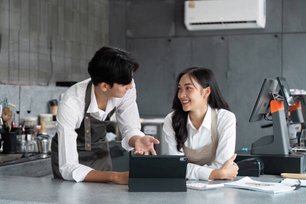 istock Young Entrepreneurs Discussing Business Strategy in a Modern Cafe Setting 2180957991