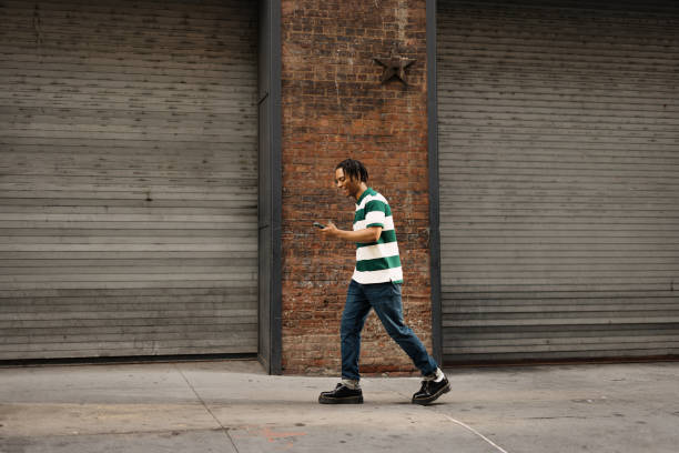 istock Happy African American man using smart phone on the move. 2180958539