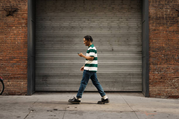 istock Carefree African American man enjoying while using cell phone on the move. 2180958572
