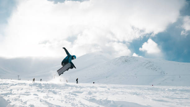 istock Man flying through the air on a snowboard 2180958732