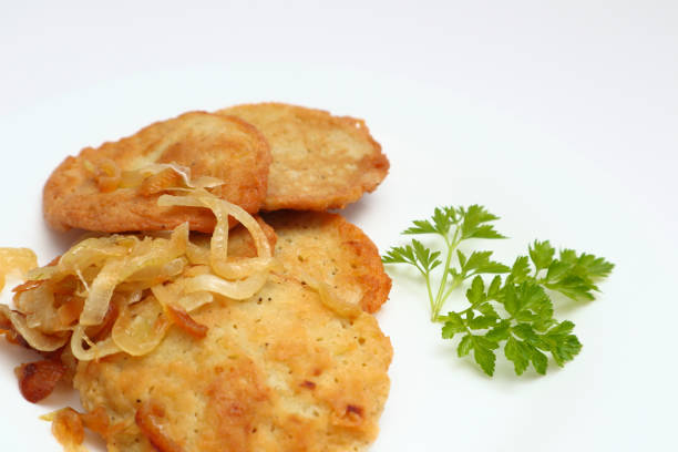 Potato pancakes or latkes or draniki on white plate. Top view. Copy space.