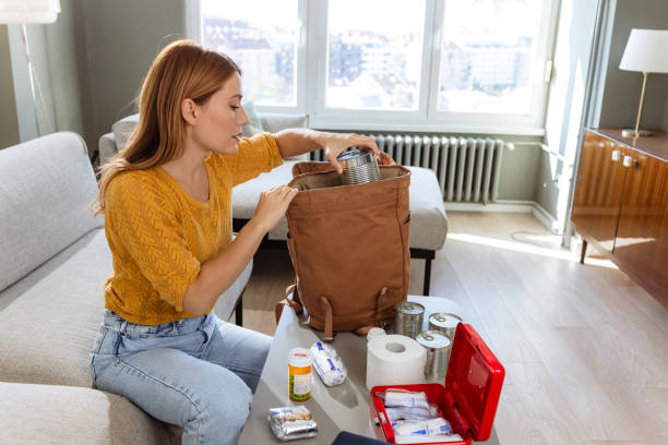istock Photo of a woman preparing a backpack for doomsday 2180960459