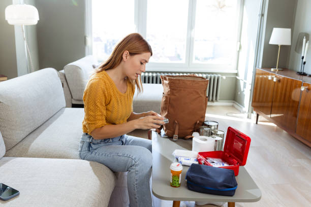 istock Young woman preparing emergency survival kit at home 2180960463