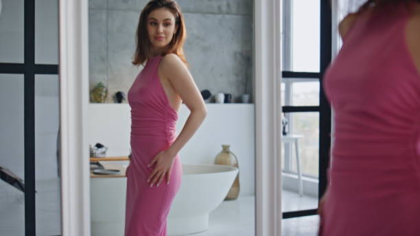 istock Elegant woman admiring mirror reflection in modern apartment bathroom closeup. 2180960862