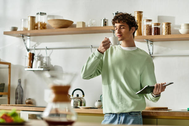 istock A young man sips coffee, enjoying his modern kitchen in a cozy morning vibe 2180961312