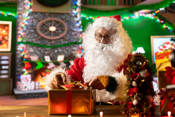 istock Saint Nicholas decorates many presents with ribbons and bows 2180963782