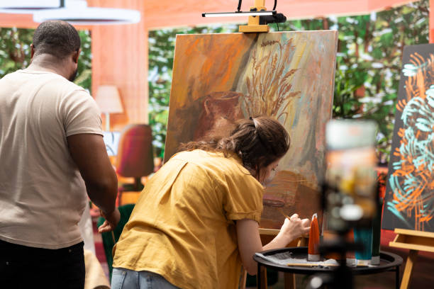 istock Skilled painters working together on an artwork in artistic workshop 2180964372