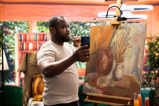 istock Young painter recording a video and self advertising his masterpiece 2180967174