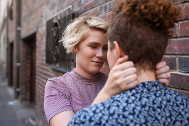 istock Romantic young lesbian couple looking into each other's eyes outside 2180967218