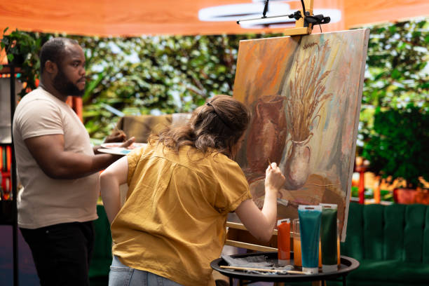 istock Team of artists painting a beautiful rustic creation on canvas 2180967536