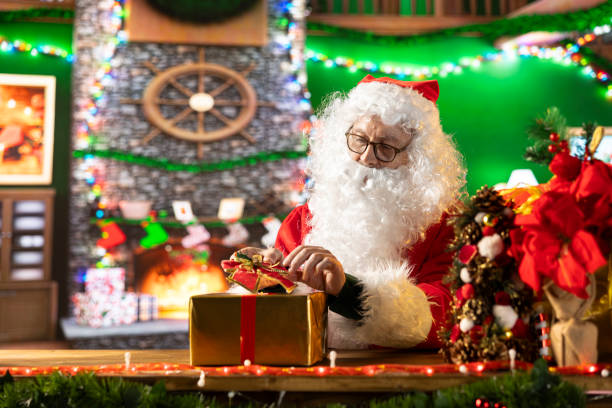 istock Saint Nicholas prepares a festive gift box by the fire 2180967860