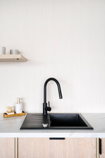 istock Black faucet and modern sink in minimalistics kitchen interior 2180973432
